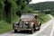 Old european car driving on a country road