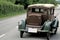 Old european car driving on a country road