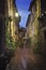 Old European city Pienza street at rainy night