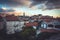 Old European city skyline with orange tile roofs and dramatic sky in antique architecture with trees in old European town Budva in