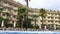 Old european hotel with pool and palms.