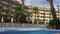 Old european hotel with pool and palms.