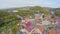 Old European town aerial shot, colorful roofs, mountains clouds