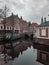 An old european town reflected in the frozen mirror of a canal