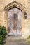 Old european wooden door on thick stone wall