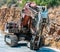 Old excavator stays near rock on Crete island