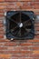 Old exhaust fan in a brick wall