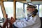 Old experienced captain in navigation cabin