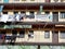 Old facade with balconies and clothes hang on it in Lavapies district of Madrid, Spain. Type of Spanish housing known as corrala.