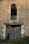 Old Facade with rustic brickwork, broken wooden door