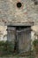 Old Facade with rustic brickwork, broken wooden door