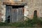 Old Facade with rustic brickwork, broken wooden door