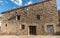 Old facade with stone cladding house in a village in spain