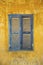 Old faded blue and yellow rustic window