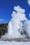 Old Faithful Geyser erupting in winter at Yellowstone National Park