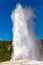 Old Faithful geyser shooting into the air in August at Yellowstone Park Wyoming
