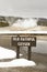 Old Faithful Geyser with sign, Yellowstone National Park, Wyoming