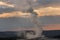 Old faithful Geyser at sunset in old faithful Basin in Yellowstone National Park