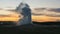 Old Faithful Geyser at sunset in Yellowstone