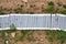 Old fallen fence made of wooden boards, top view. Path on the ground from the planks of the old fencing