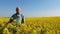 Old farmer in field of rapeseed