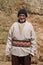 Old farmer man with Hay bales on background. Elderly muslim farmer