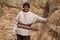 Old farmer man with Hay bales on background. Elderly muslim farmer