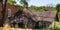 Old farmhouse with thatched roof shattered and abandoned