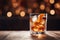 Old fashion cocktail on a wooden table. Beautiful background with bokeh