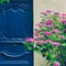 Old fashioned blue door with colorful flowers