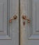 Old-Fashioned Bronze Handles of Gray Door
