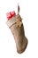 An old fashioned burlap Christmas Stocking isolated on white. A moose shaped holiday cookie and present fill the bag