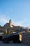 Old-fashioned cannons stand in the foreground of a quaint rural village in Ibiza