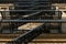 Old-fashioned cast-iron fire-escape on the outside of an apartment building in New York City`s Harlem neighborhood, NYC