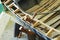 Old fashioned clamp holding curved wood being used to build a wooden boat