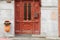 Old fashioned close up of vintage enter door with symmetrical ornamentOld vintage red doors with glass windows with concrete facad