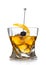 Old fashioned cocktail glass with ice cubes and blackberry on still pick on white background with orange peel