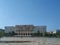 Old fashioned communist socialist European small town government architecture building and blue sky above on Tirana main square on