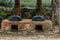 Old fashioned cooking cauldrons in primitive earth oven