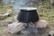 Old fashioned cooking stove with metal steel pans on a fire. Cooking food by scout at camping scout . the water evaporates from