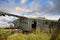 Old-fashioned crashed and abandoned small propeller plane. Airplane graveyard