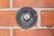 Old fashioned door bell in brickwork with the word Press