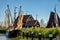 Old fashioned fishing boat dries the fishing nets with historic fishermen`s cottages in the background