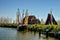 Old-fashioned fishing boat with the fish traps in the mast and a fisherman`s cottage in the background