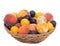 Old fashioned fruit from a long abandoned orchard in old wicker basket, bowl. Tiny plums, small, sweet peaches etc