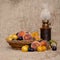 Old fashioned heritage fruit from a long abandoned orchard in an old wicker bowl, with vintage oil lamp on hessian