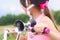 Old fashioned horn with chrome trumpet and black rubber bulb close-up mounted on a children`s bike. Little girl in a