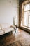 Old fashioned interior big wooden window and mirror, white sofa in old vintage living room with brick walls