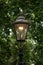 Old fashioned iron street lamp on The Mall in central London, lit up at dusk