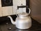 Old fashioned kettle on hob